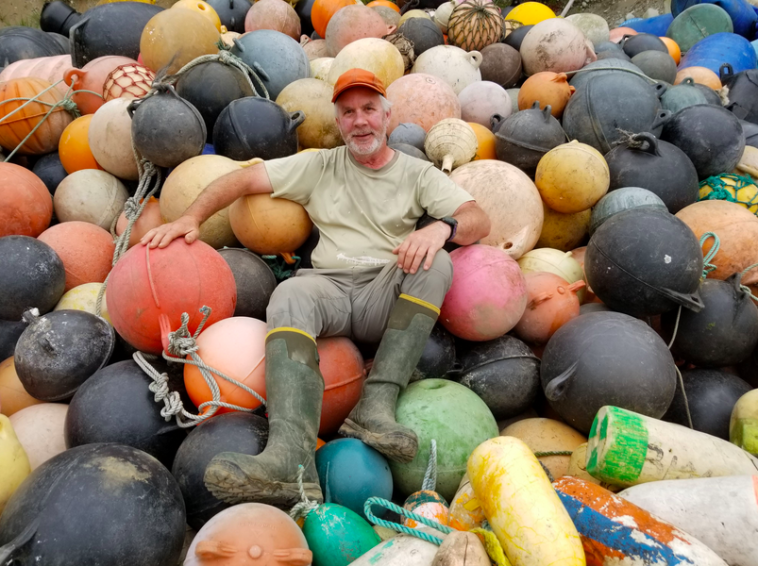 Artist Pete Clarkson sitting amidst the medium he uses for his sculptures. Credit: Clarkson