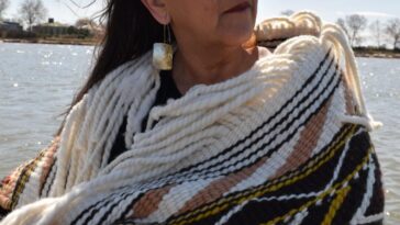 A woman wearing Coast Salish blankets.