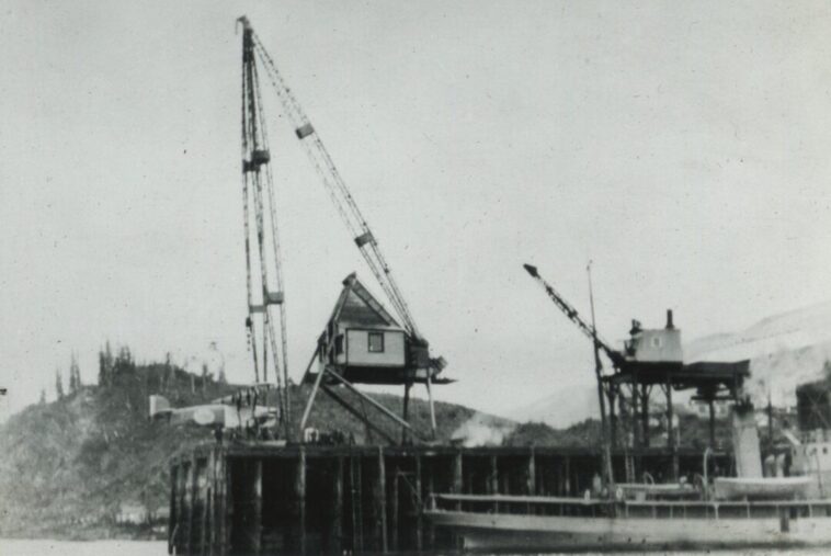 View of one of the Douglas World Cruiser aircraft being hoisted out of the water for repairs at Prince Rupert, BC, in April 1924.